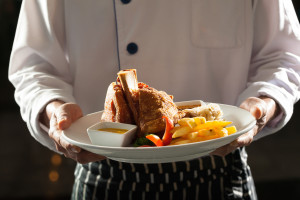 image of chef holding a platter