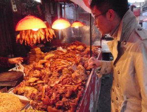 CET - Study abroad in Harbin China | Abroad101 Blog image of guy looking at food in china