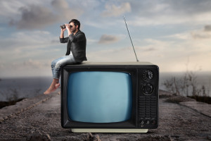 Image of a man on a TV looking for a study abroad program