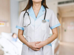 Study Abroad 2 | Abroad101 Blog Woman in white button-up shirt wearing a blue stethoscope while study nursing abroad.
