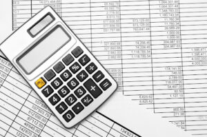 1 | Abroad101 Blog A calculator placed on top of spreadsheets, symbolizing budgeting and financial planning for students studying abroad.