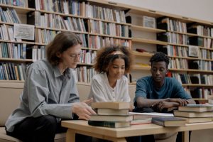 pexels-cottonbro-6344238 | Abroad101 Blog Three international students studying together in a library, representing the academic and cultural challenges of studying abroad.