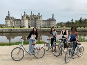 APA spring 2024 Chambord | Abroad101 Blog Four APA Spring 2024 students stand with bicycles at the Château de Chambord during a French-immersion study-abroad excursion in France.