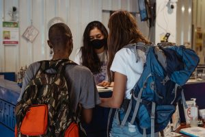pexels-ketut-subiyanto-4907454 | Abroad101 Blog Students with backpacks checking in at an accommodation reception desk on arrival for study abroad.
