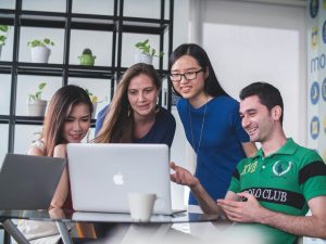mimi-thian-vdXMSiX-n6M-unsplash | Abroad101 Blog Group of international students collaborating on a laptop, planning a semester study abroad and comparing programs and credits.