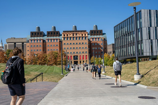 Smart Campus Safety at a Modern University | Abroad101 Blog Students walking through a modern university campus with academic buildings and residence facilities